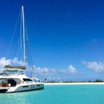 yacht pulling up to island