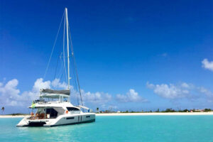 yacht pulling up to island